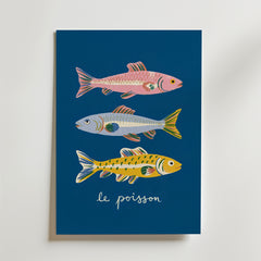 Bozetto French Fish Illustration Poster föreställer tre färgglada fiskar - rosa, blå och gul - på en mörkblå bakgrund med "le poisson" i kursiv stil nedanför.