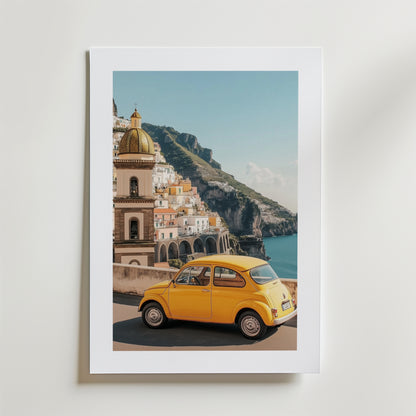 Bozetto Amalfi Coast Car Poster visar en gul veteranbil vid havet, färgglada byggnader och en kupol på klippiga klippor - allt för att fånga Medelhavets charm med en högkvalitativ finish.