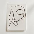 Dreamy Line Art Face Poster" av Bozetto föreställer ett lugnt ansikte med slutna ögon och böjda läppar, tecknat med minimalistiska svarta linjer på vit canvas för en elegant, abstrakt look.