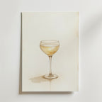 Elegant Cocktail Poster by Bozetto visar ett coupeglas med ljusgul vätska på en vit bakgrund med en svag skugga, tryckt på premiumpapper för hållbar kvalitet.